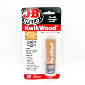 J-B Weld KwikWood epoxy putty stick in red and black blister pack, tan repair color