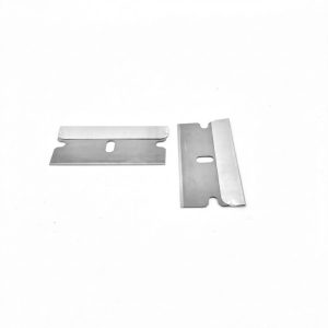 Two single-edge razor blades with reinforced steel backs on a white background