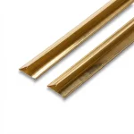 Two lengths of folded brass-colored V-Bronze weatherstrip with spring edges